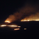 A Controlled fire burns a field in the middle of the night in rural Kansas.